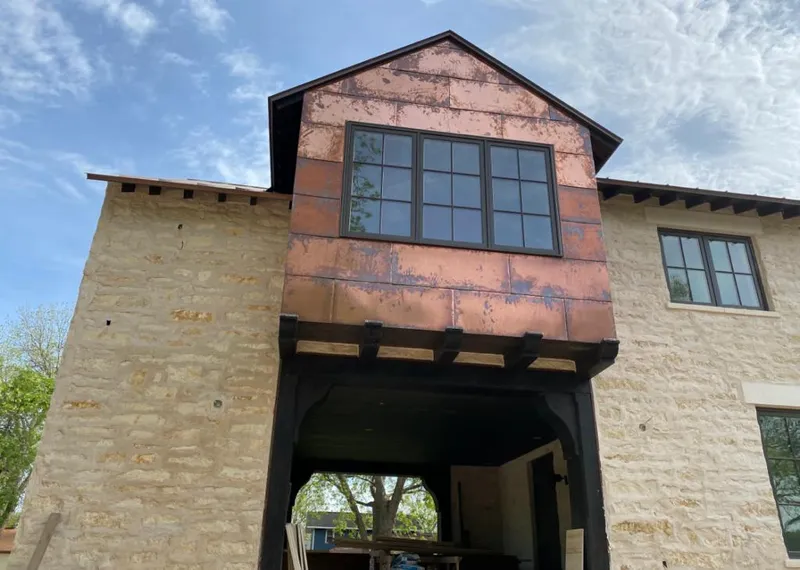 Copper metal panel facade on a stone building for Metal Roof Coating in Orangeburg