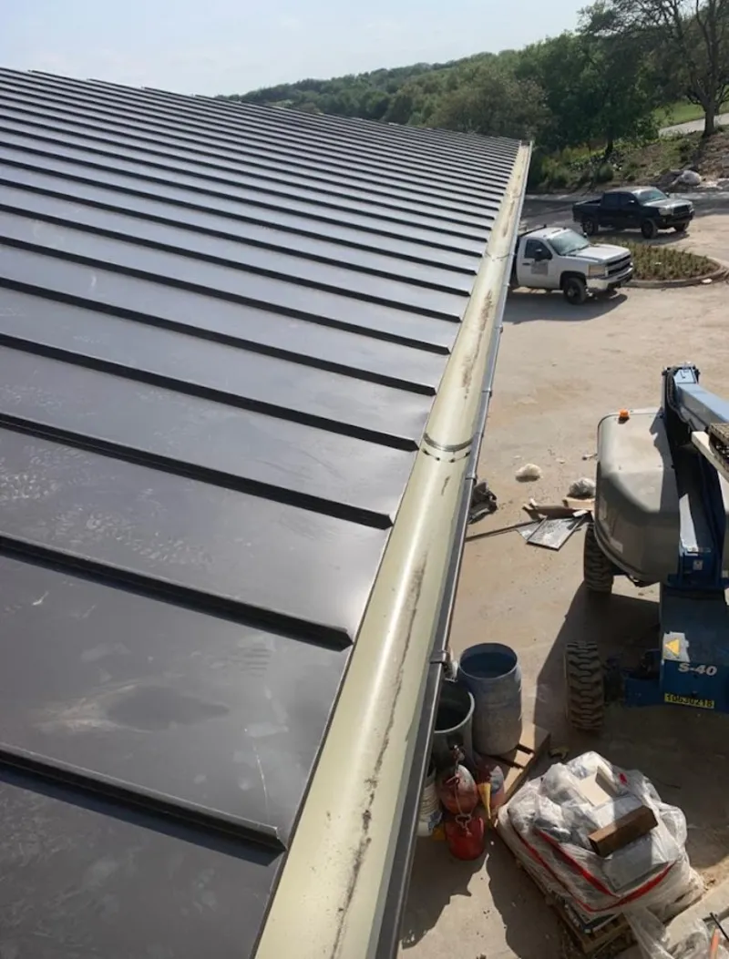 Standing seam panel and gutter detail on a metal roofing jobsite in Orangeburg